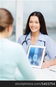 healthcare, medicine, radiology and technology concept - female smiling doctor or nurse showing x-ray on tablet pc