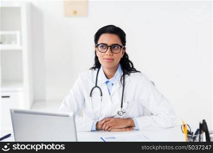 healthcare, people and medicine concept - female doctor in white coat with laptop computer and clipboard at hospital. doctor with laptop and clipboard at hospital
