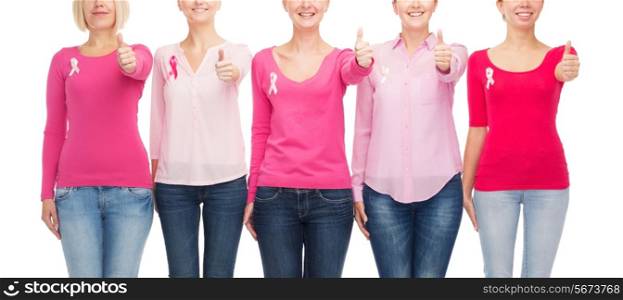 healthcare, people, gesture and medicine concept - close up of smiling women in blank shirts with pink breast cancer awareness ribbons over white background