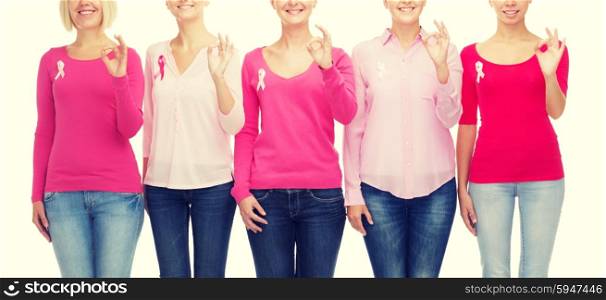 healthcare, people, gesture and medicine concept - close up of smiling women in blank shirts with pink breast cancer awareness ribbons showing ok sign over white background
