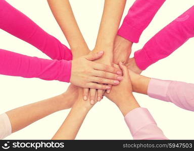 healthcare, people, gesture and medicine concept - close up of women hands on top of each other over white background