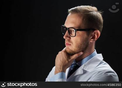 healthcare, people, profession and medicine concept - close up of male doctor in white coat over black background