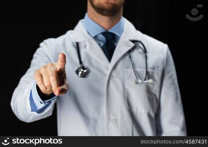 healthcare, people, profession and medicine concept - close up of male doctor in white coat with stethoscope touching something imaginary over black background