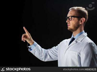 healthcare, people, profession and medicine concept - close up of male doctor touching something imaginary over black background