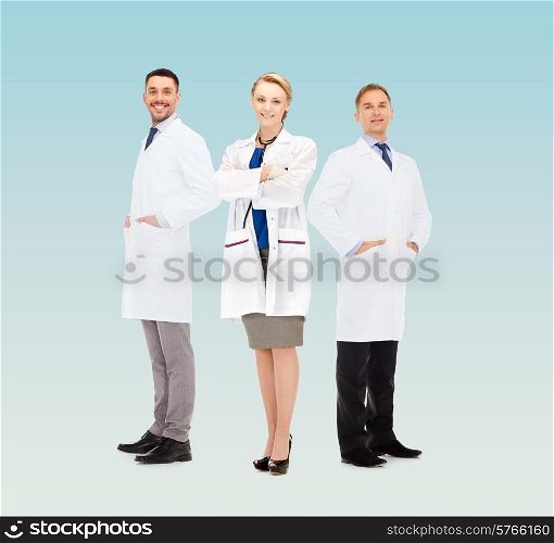 healthcare, profession and medicine concept - group of smiling doctors in white coats over blue background