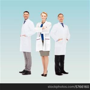 healthcare, profession and medicine concept - group of smiling doctors in white coats over blue background