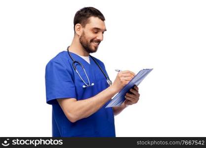 healthcare, profession and medicine concept - happy smiling doctor or male nurse in blue uniform writing medical report on clipboard over white background. male doctor writing medical report on clipboard
