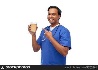 healthcare, profession and medicine concept - happy smiling indian doctor or male nurse in blue uniform with takeaway coffee cup and stethoscope over white background. male doctor with stethoscope drinking coffee