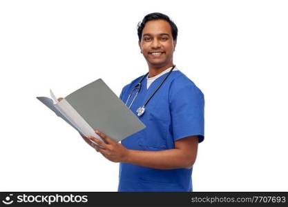 healthcare, profession and medicine concept - happy smiling indian doctor or male nurse in blue uniform with folder report over white background. happy indian doctor with medical report in folder