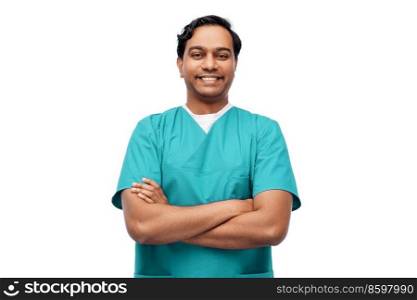 healthcare, profession and medicine concept - happy smiling indian doctor or male nurse in blue uniform with crossed arms over white background. happy indian doctor or male nurse in blue uniform