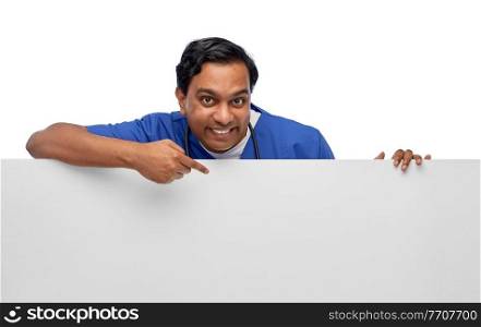 healthcare, profession and medicine concept - happy smiling indian male doctor or nurse in blue uniform with big board over white background. smiling male doctor or nurse with big white board
