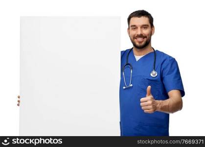 healthcare, profession and medicine concept - happy smiling male doctor or nurse in blue uniform with big board showing thumbs up over white background. male doctor with white board showing thumbs up
