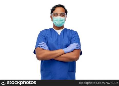 healthcare, profession and medicine concept - indian doctor or male nurse in blue uniform and face protective medical mask for protection from virus disease over white background. indian male doctor in blue uniform and mask