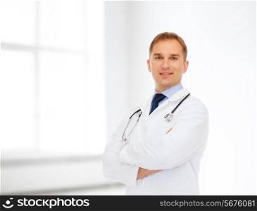 healthcare, profession and medicine concept - smiling male doctor in white coat with stethoscope over white room background