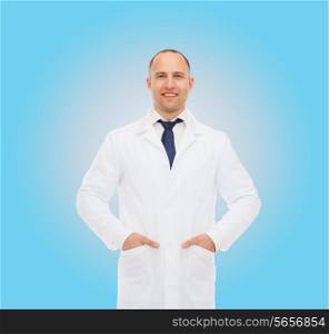 healthcare, profession and medicine concept - smiling male doctor in white coat over blue background