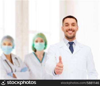 healthcare, profession and medicine concept - smiling male doctor showing thumbs up over white background