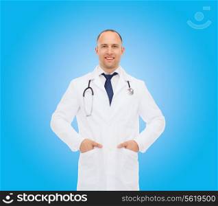 healthcare, profession and medicine concept - smiling male doctor with stethoscope in white coat over blue background