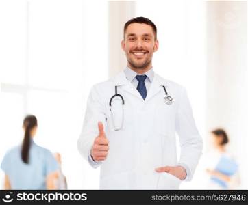 healthcare, profession and medicine concept - smiling male doctor with stethoscope showing thumbs up over white background