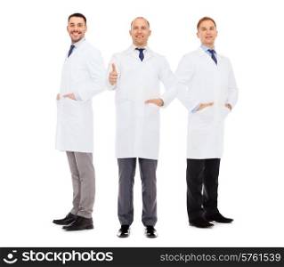 healthcare, profession and medicine concept - smiling male doctors in white coats over white background