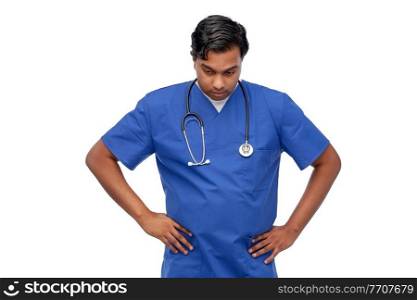 healthcare, profession and medicine concept - stressed indian doctor or male nurse in blue uniform over white background. stressed doctor or male nurse in blue uniform