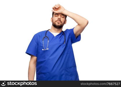 healthcare, profession and medicine concept - tired doctor or male nurse in blue uniform with stethoscope over white background. tired doctor or male nurse with stethoscope