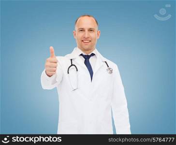 healthcare, profession, gesture and medicine concept - smiling male doctor with stethoscope showing thumbs up over blue background