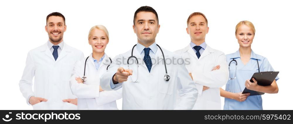 healthcare, profession, gesture, people and medicine concept - group of doctors with stethoscopes and clipboard pointing at you