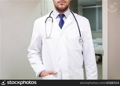 healthcare, profession, people and medicine concept - close up of doctor in white coat with stethoscope at hospital