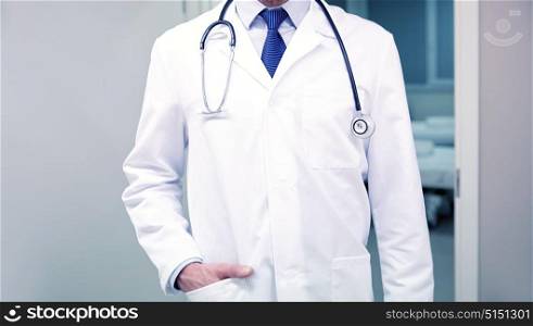 healthcare, profession, people and medicine concept - close up of doctor in white coat with stethoscope at hospital. close up of doctor with stethoscope at hospital