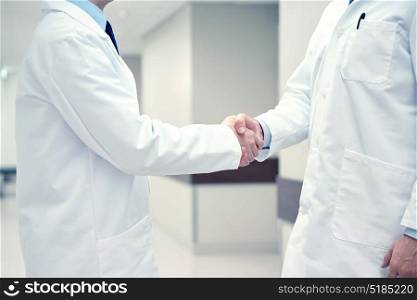 healthcare, profession, people and medicine concept - close up of doctors making handshake. close up of doctors making handshake