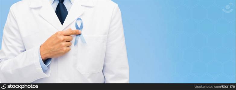 healthcare, profession, people and medicine concept - close up of male doctor hand with sky blue prostate cancer awareness ribbon