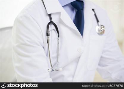 healthcare, profession, people and medicine concept - close up of male doctor with stethoscope. close up of male doctor with stethoscope