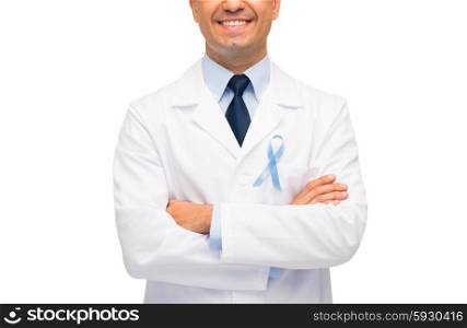 healthcare, profession, people and medicine concept - close up of smiling male doctor in white coat with sky blue prostate cancer awareness ribbon