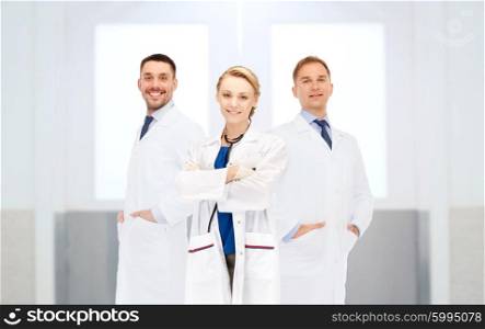healthcare, profession, people and medicine concept - group of happy doctors at hospital