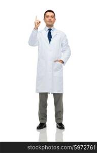 healthcare, profession, people and medicine concept - male doctor in white coat pointing finger up