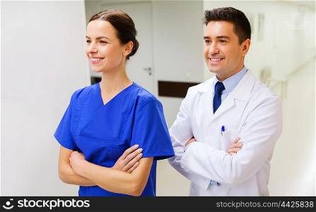 healthcare, profession, people and medicine concept - smiling doctor in white coat and nurse at hospital