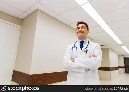 healthcare, profession, people and medicine concept - smiling male doctor in white coat with stethoscope at hospital