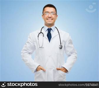 healthcare, profession, people and medicine concept - smiling male doctor in white coat and eyeglasses with stethoscope over blue background