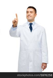 healthcare, profession, people and medicine concept - smiling male doctor in white coat touching or pointing finger to something imaginary