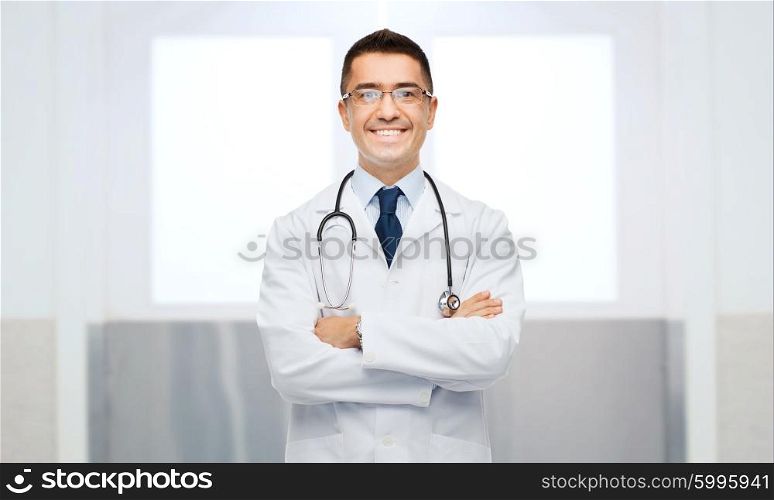 healthcare, profession, people and medicine concept - smiling male doctor in white coat and eyeglasses with stethoscope
