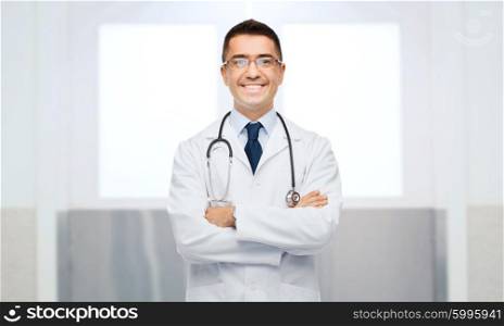 healthcare, profession, people and medicine concept - smiling male doctor in white coat and eyeglasses with stethoscope