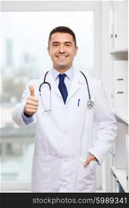 healthcare, profession, people and medicine concept - smiling male doctor in white coat at medical office