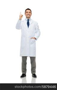 healthcare, profession, people and medicine concept - smiling male doctor in white coat pointing finger up