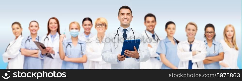 healthcare, profession, people, technology and medicine concept - international group of doctors with tablet pc computer and clipboard over gray background