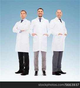 healthcare, profession, teamwork and medicine concept - group of smiling male doctors in white coats over blue background