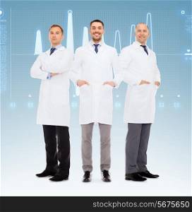 healthcare, profession, teamwork and medicine concept - group of smiling male doctors in white coats over blue background with cardiogram