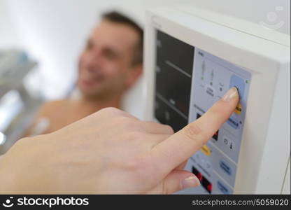 healthcare provider pressing the machine