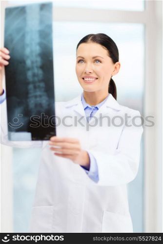 healthcare, radiology and medicine concept - smiling young doctor in cabinet