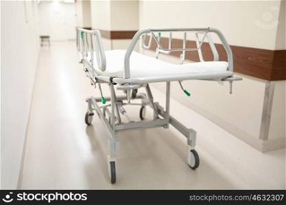 healthcare, reanimation, emergency room and medicine concept - gurney or wheeled stretcher at hospital corridor