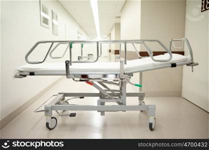 healthcare, reanimation, emergency room and medicine concept - gurney or wheeled stretcher at hospital corridor